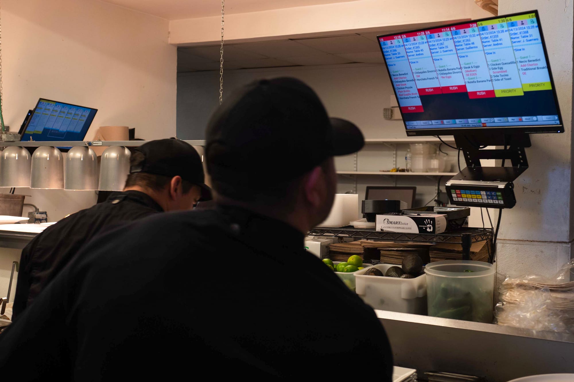 Kitchen staff looking at a kitchen system display