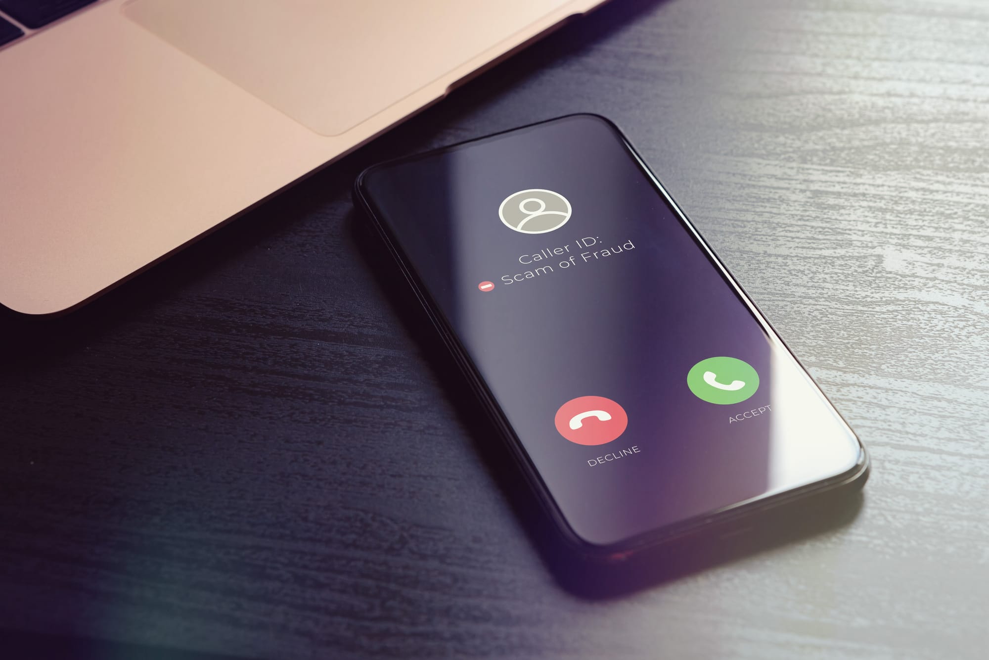 phone ringing with a message that says "Caller ID: Scam or Fraud"