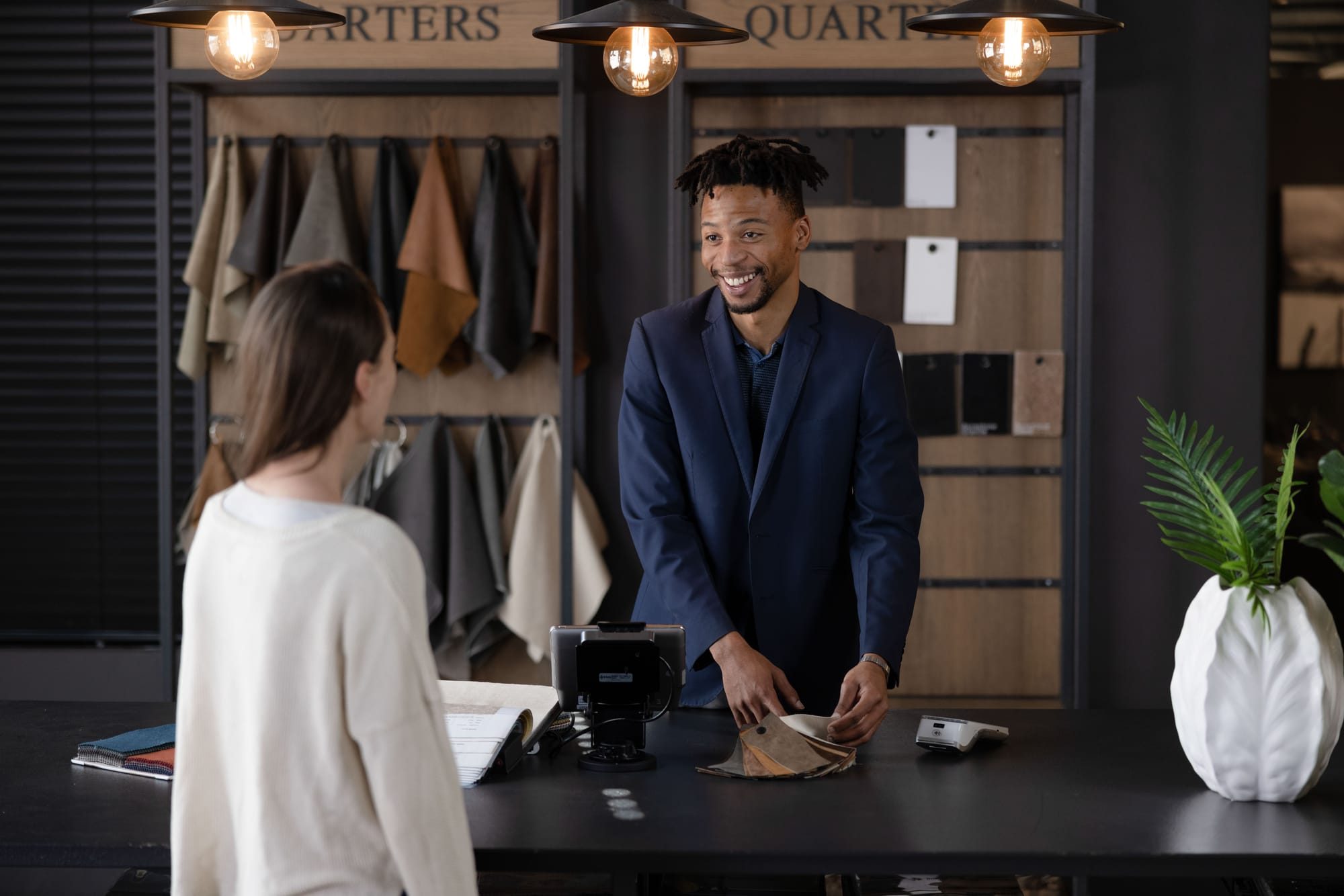 Customer making a sale on a POS system from SpotOn in a retail shop.