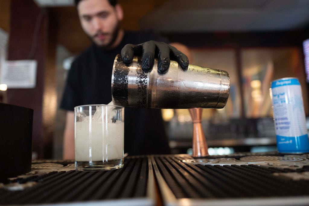 Bartender pours a drink