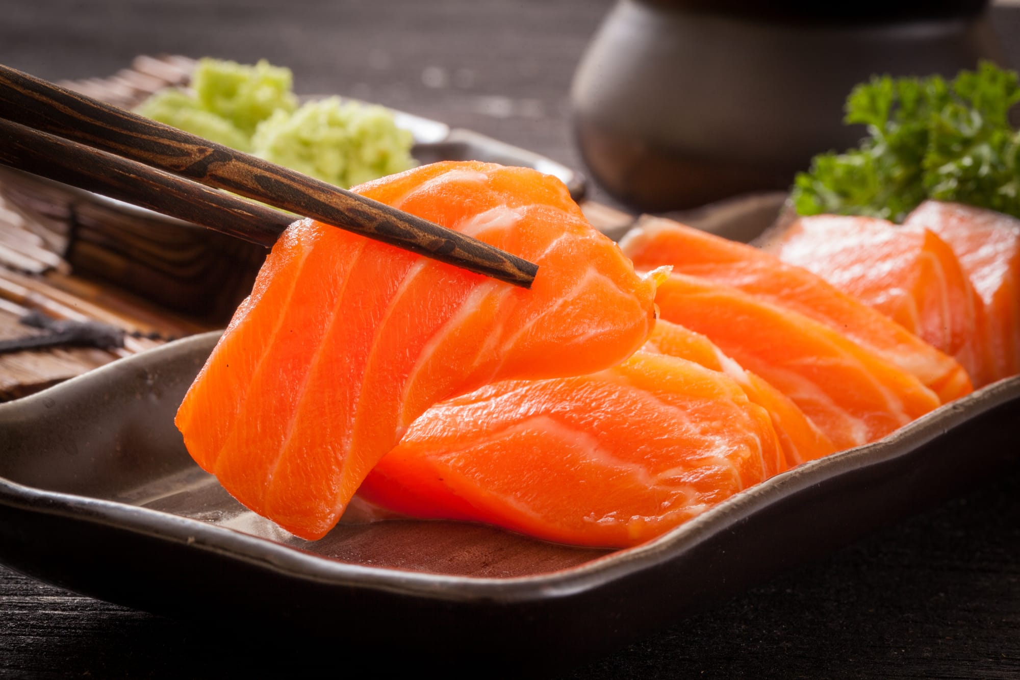 Sashimi slices of salmon or tuna fish vs maki roll