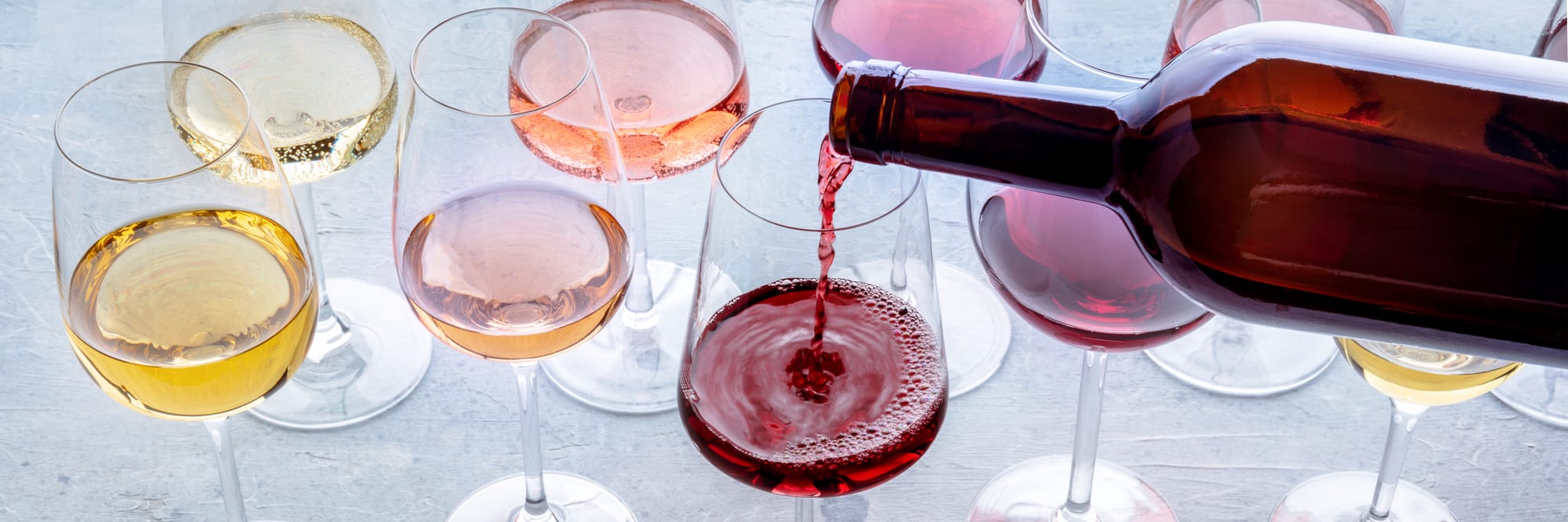 Wine bottle restaurant pouring into glass for guests