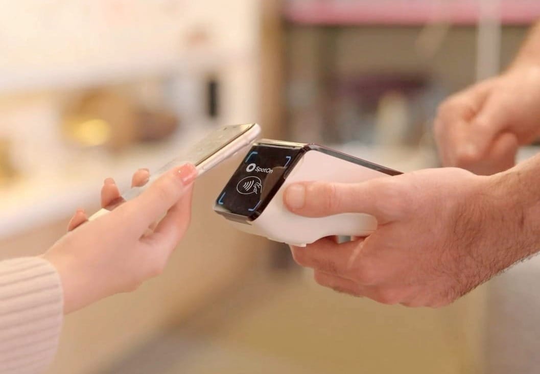 A customer taps their phone onto a payment terminal