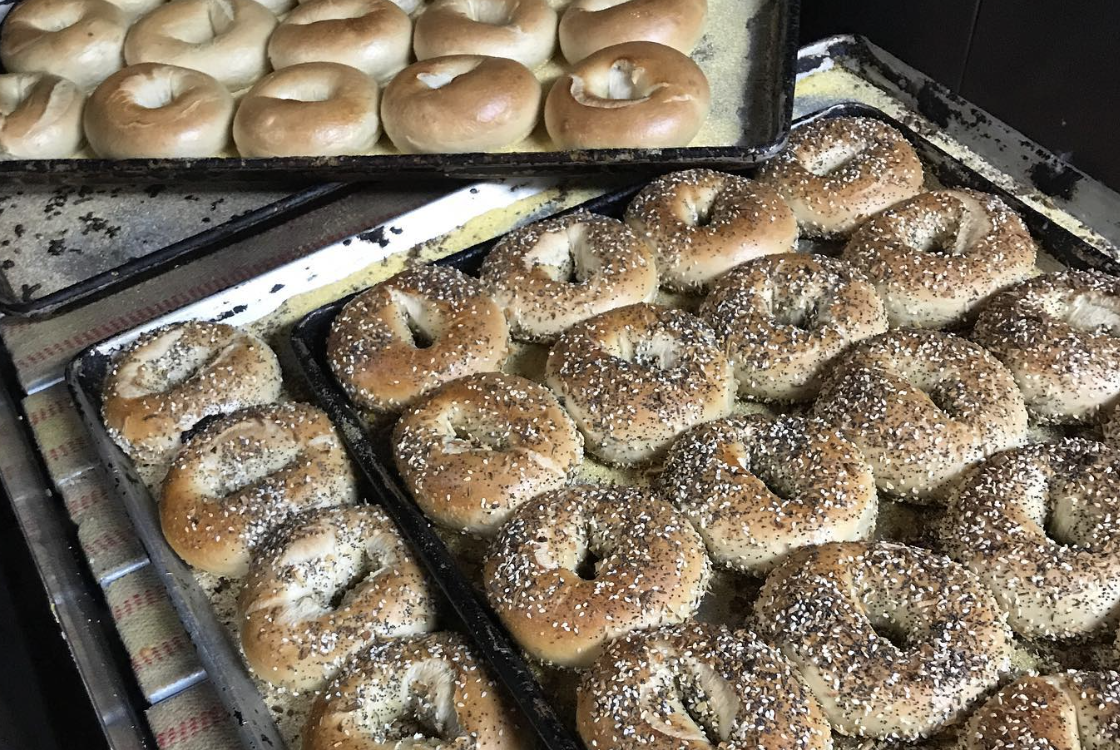 Freshly baked bagels right out of the oven at IV Bagel Cafe, ready to eat with lox and cream chees.